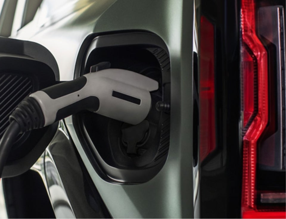 Close up of charging port with charger plugged in on a GMC Hummer EV SUV - Vachon GMC in Putnam CT